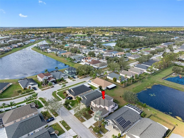 bird's eye view featuring a water view and a residential view