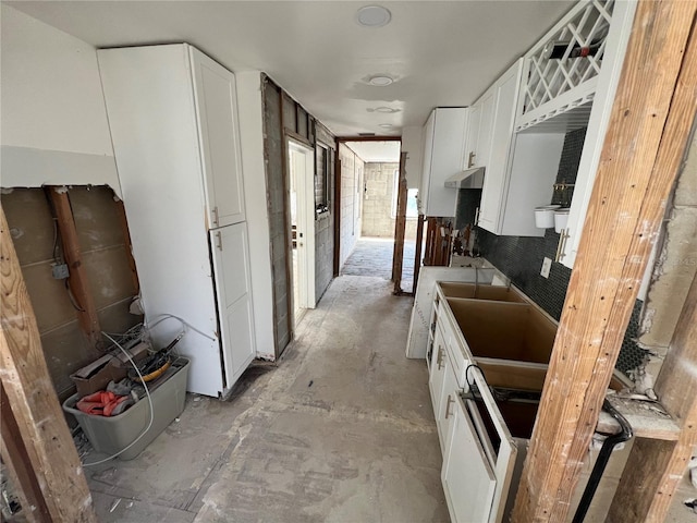 507 79th Ave, St Pete Beach, FL 33706 - kitchen featuring under cabinet range hood and white cabinets
