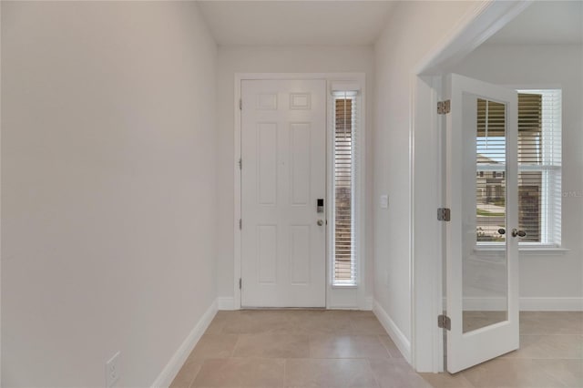 tiled entryway featuring a wealth of natural light