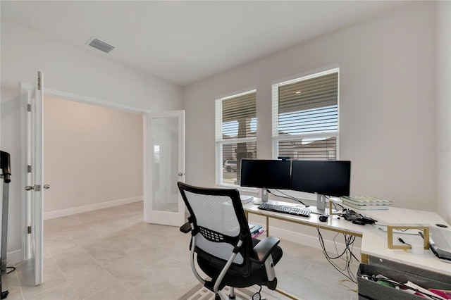 office space with french doors and light tile patterned floors