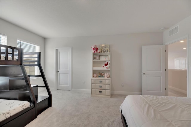 bedroom featuring light carpet