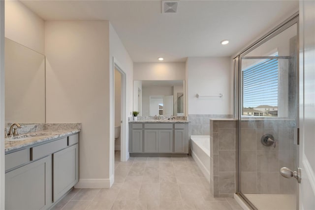 full bathroom with tile patterned flooring, vanity, toilet, and independent shower and bath