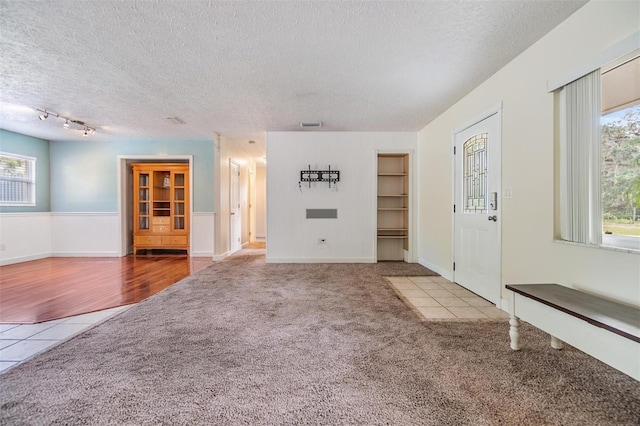 unfurnished living room with hardwood / wood-style floors and a textured ceiling