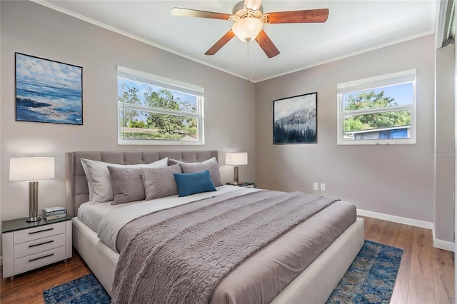 bedroom with hardwood / wood-style flooring, ceiling fan, ornamental molding, and multiple windows