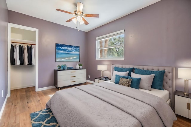 bedroom with ceiling fan, a closet, and light wood-type flooring