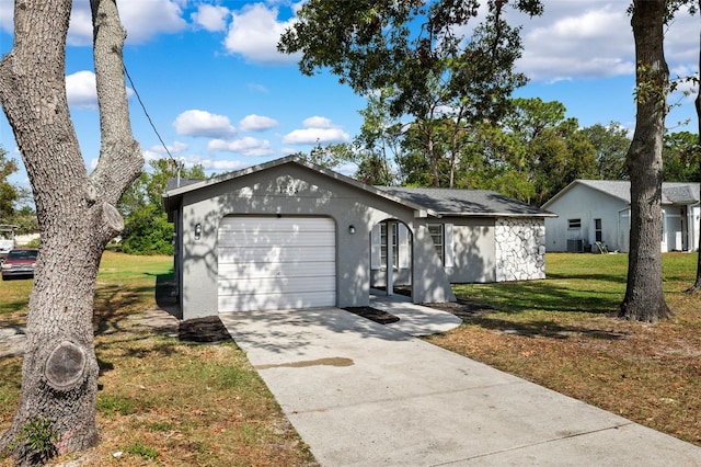 single story home featuring a front lawn and a garage