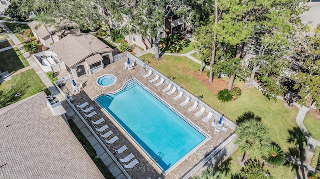 community pool with fence and a patio area