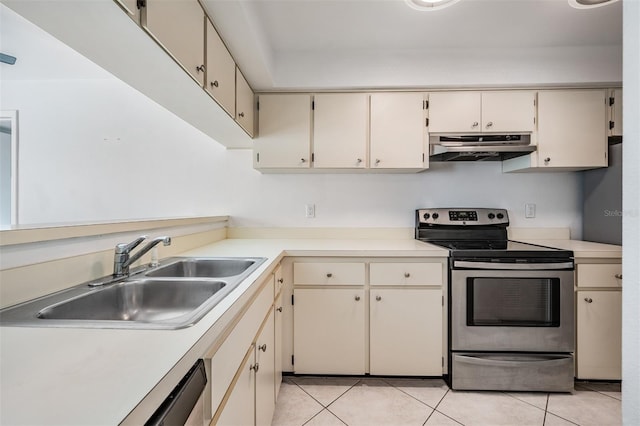 kitchen featuring under cabinet range hood, stainless steel range with electric cooktop, light countertops, and a sink