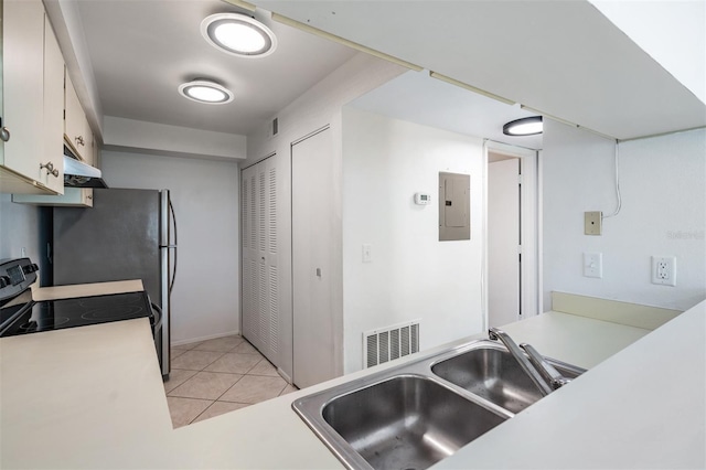 kitchen with visible vents, electric panel, under cabinet range hood, stainless steel electric range, and light tile patterned floors