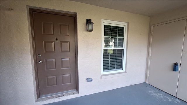 doorway to property with stucco siding