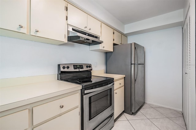 kitchen featuring cream cabinetry, under cabinet range hood, stainless steel appliances, light countertops, and light tile patterned floors