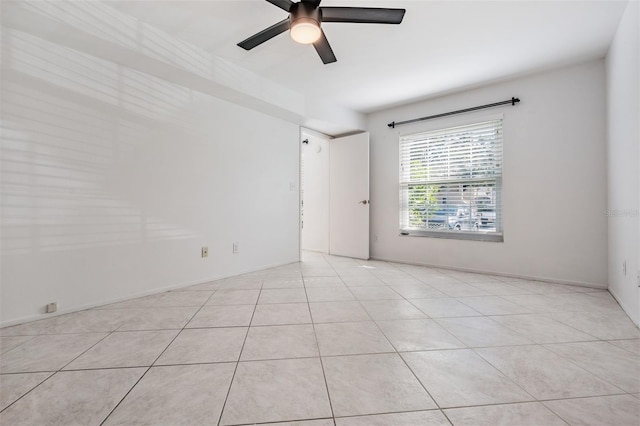 unfurnished room featuring light tile patterned flooring and ceiling fan