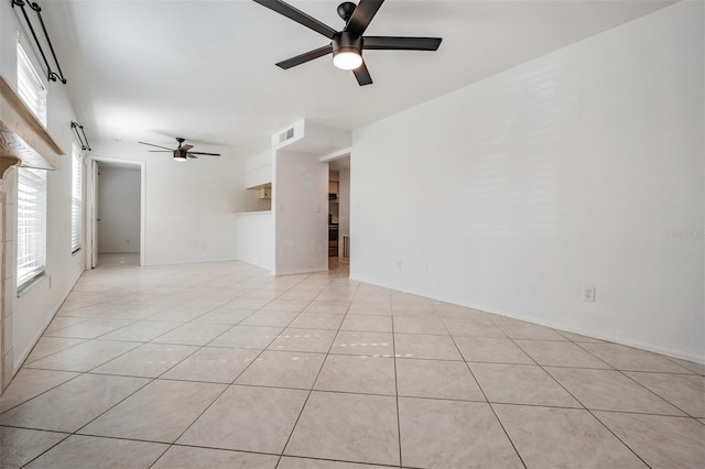 spare room with light tile patterned floors, visible vents, and ceiling fan