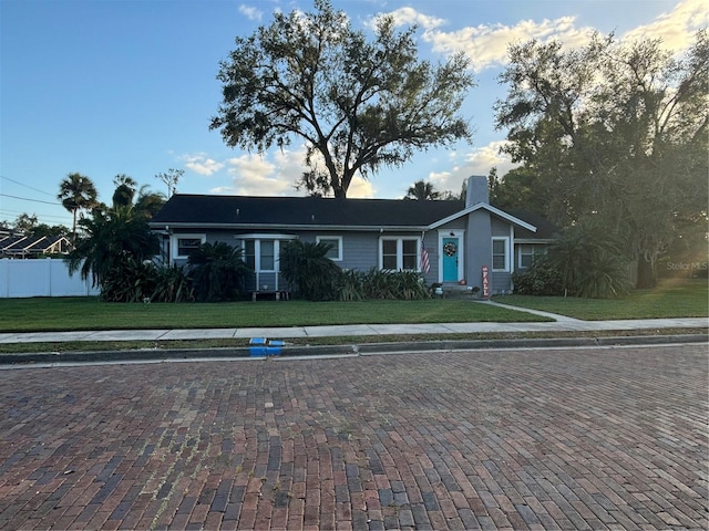 ranch-style home with a front lawn