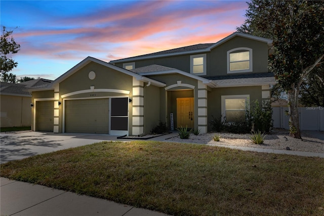 view of front of house with a lawn and a garage