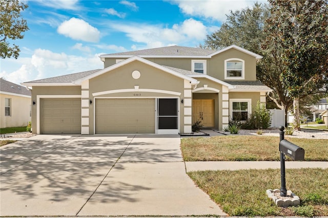 view of front property with a garage and a front yard