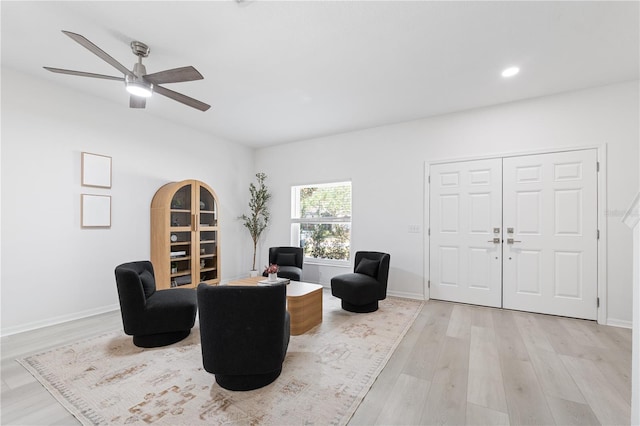 living area with ceiling fan and light wood-type flooring