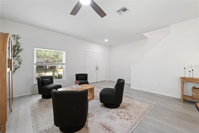 sitting room featuring ceiling fan and light hardwood / wood-style flooring