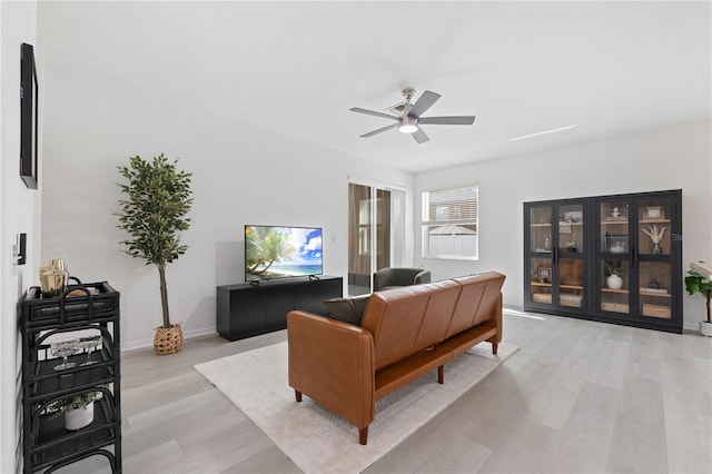 living room with ceiling fan and light wood-type flooring