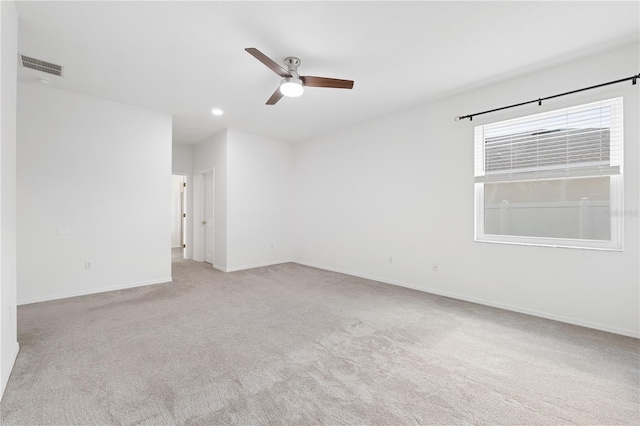 unfurnished room featuring light carpet and ceiling fan