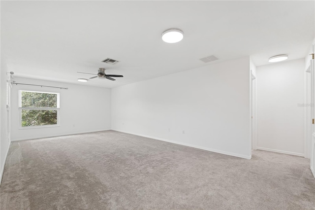 carpeted spare room with ceiling fan