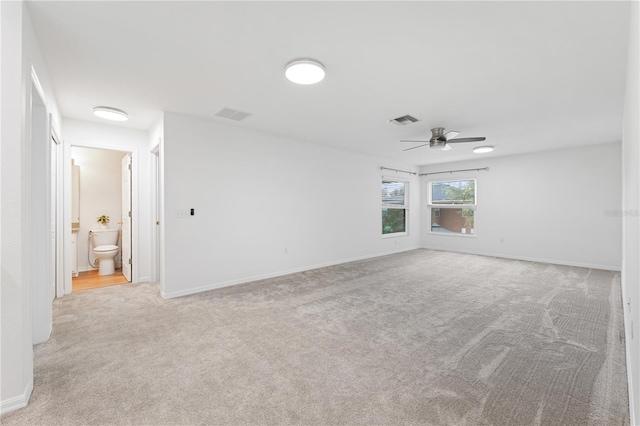 empty room featuring light carpet and ceiling fan