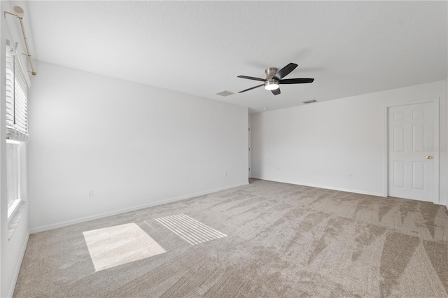 carpeted empty room featuring ceiling fan