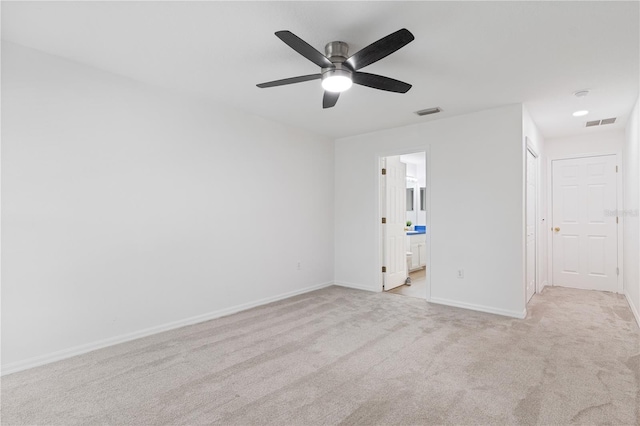 unfurnished room with ceiling fan and light colored carpet