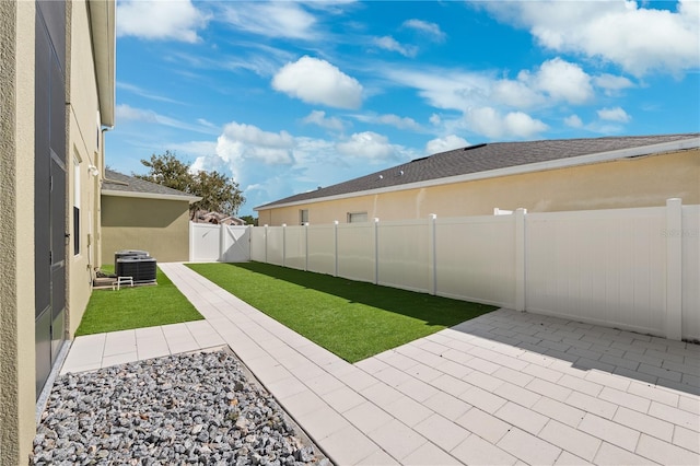 view of yard featuring a patio area and central AC