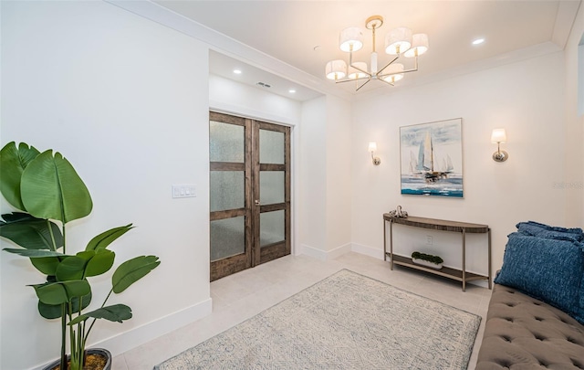 foyer entrance with a chandelier, light tile patterned floors, and crown molding