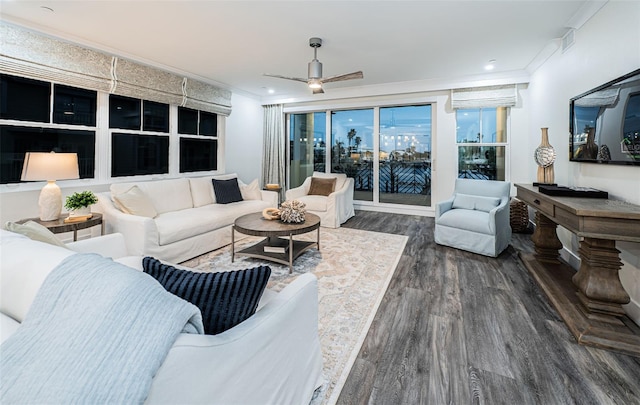 living room featuring dark hardwood / wood-style flooring, ceiling fan, and ornamental molding