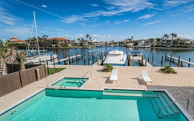 exterior space with a boat dock, a water view, a community hot tub, and a patio