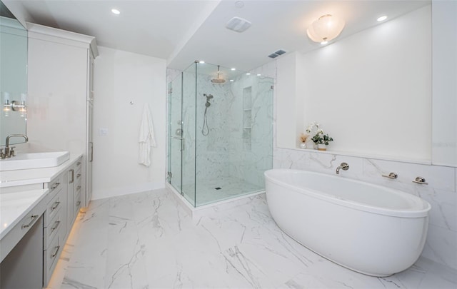 bathroom with vanity and separate shower and tub