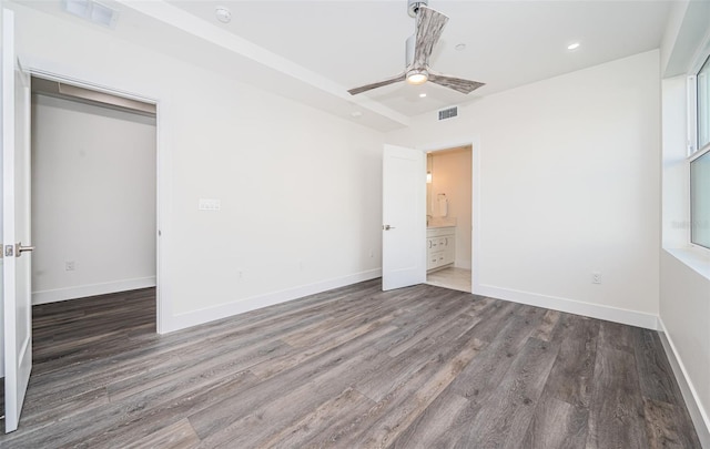 unfurnished bedroom featuring a closet, dark wood-type flooring, and ceiling fan