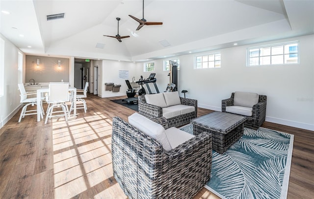 living room with a wealth of natural light, ceiling fan, lofted ceiling, and hardwood / wood-style flooring