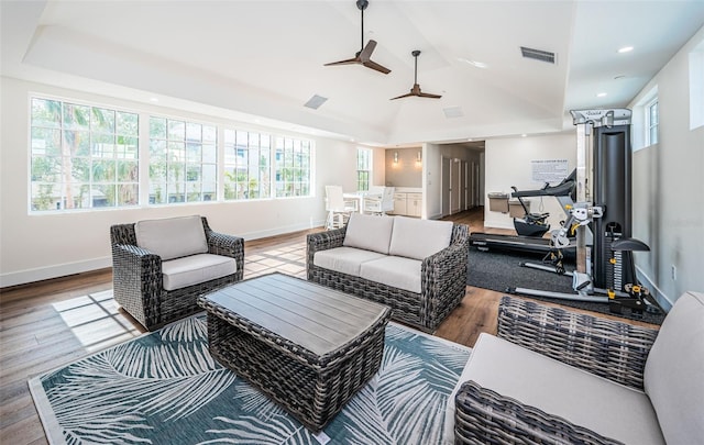 living room with ceiling fan, plenty of natural light, lofted ceiling, and hardwood / wood-style flooring