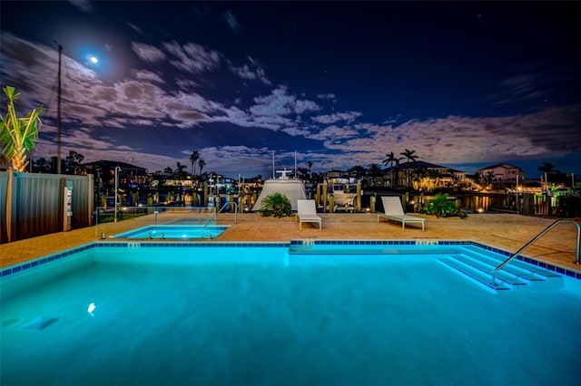 view of pool at dusk