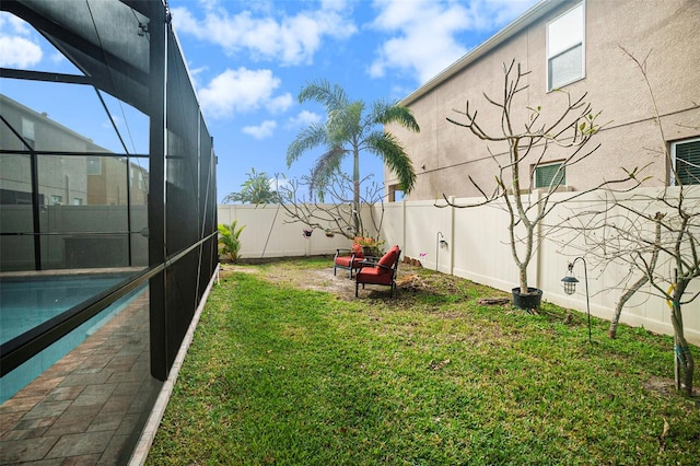 view of yard with glass enclosure and a fenced in pool