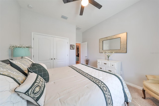 carpeted bedroom with ceiling fan and a closet