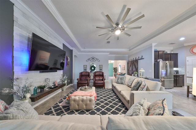 living room with ceiling fan and ornamental molding