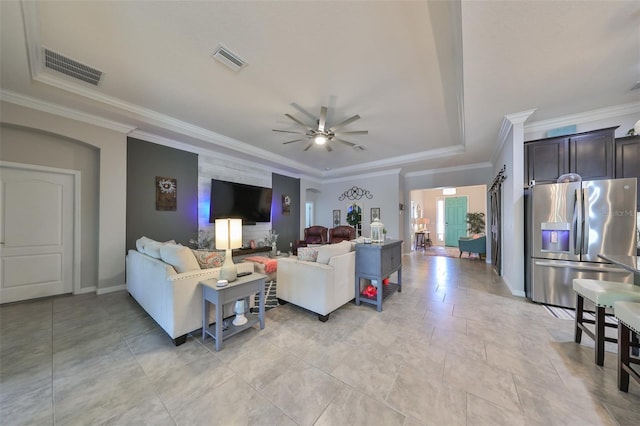 living room with ceiling fan and crown molding