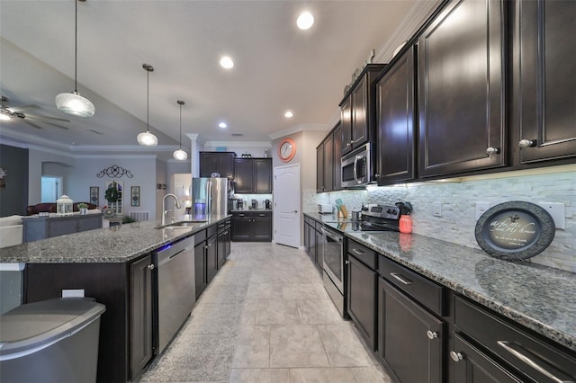 kitchen with a large island, tasteful backsplash, crown molding, decorative light fixtures, and appliances with stainless steel finishes