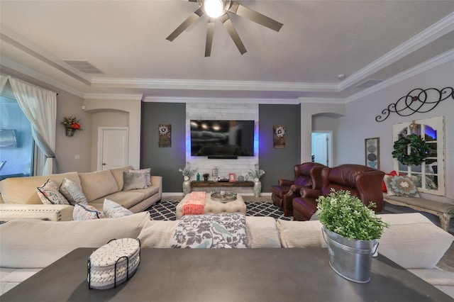 living room featuring ceiling fan and ornamental molding