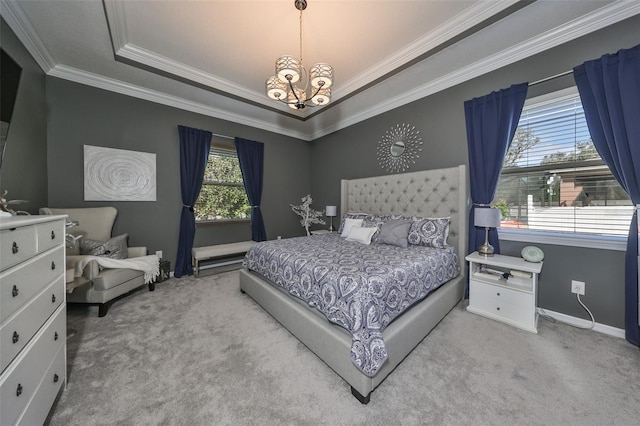 carpeted bedroom with a chandelier, a raised ceiling, and crown molding