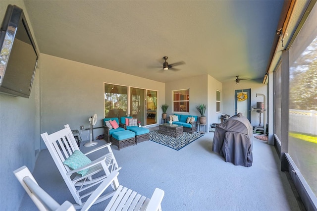 sunroom featuring ceiling fan