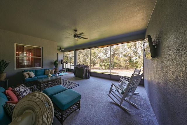 sunroom / solarium featuring plenty of natural light and ceiling fan