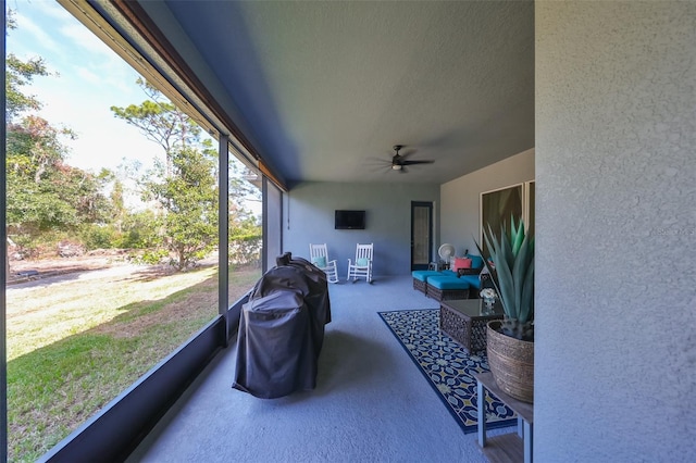 sunroom / solarium featuring ceiling fan