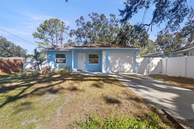 view of front facade featuring stucco siding, a front lawn, driveway, and fence