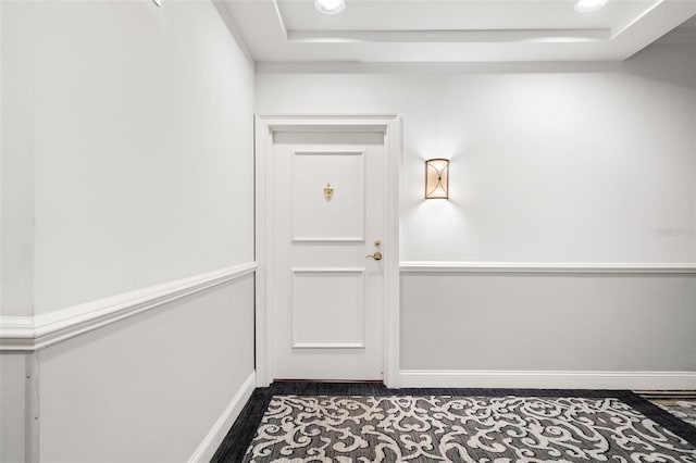 doorway with a tray ceiling