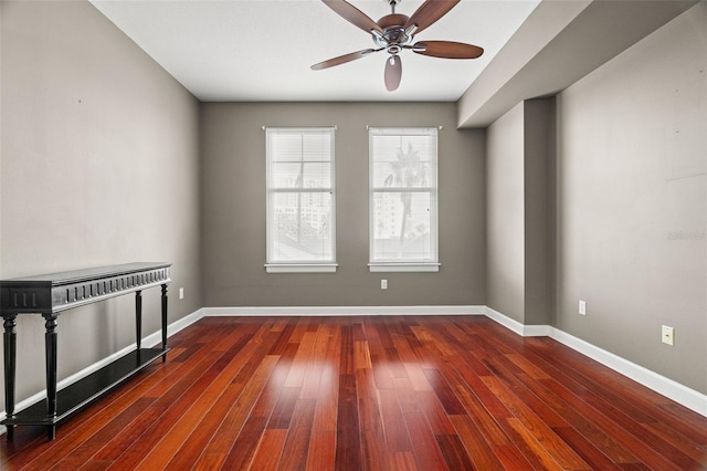 empty room featuring dark hardwood / wood-style flooring and ceiling fan